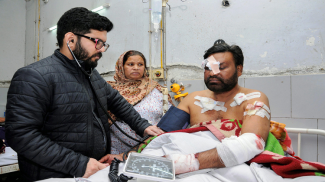 An injured victim being treated at a hospital in Amritsar after two men on a motorcycle reportedly threw a grenade at the Nirankari Bhawan in Amritsar - Sakshi Post