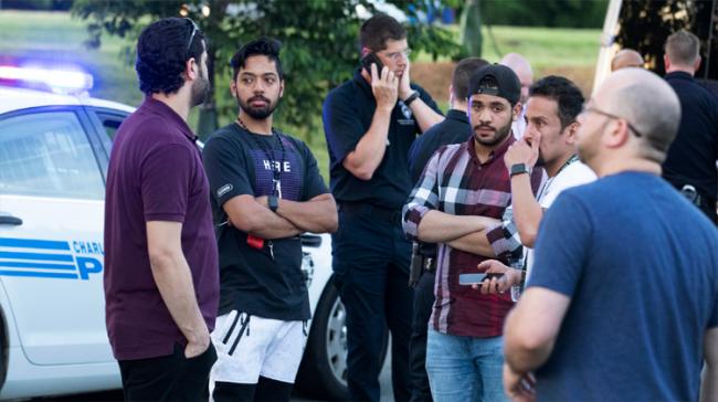 people gather  across from the UNC Charlotte  campus after a fatal shooting  people gather  across from the UNC Charlotte  campus after a fatal shooting  - Sakshi Post