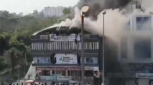 Devastating fire at a coaching centre atop a four-storey building in Sarthana - Sakshi Post