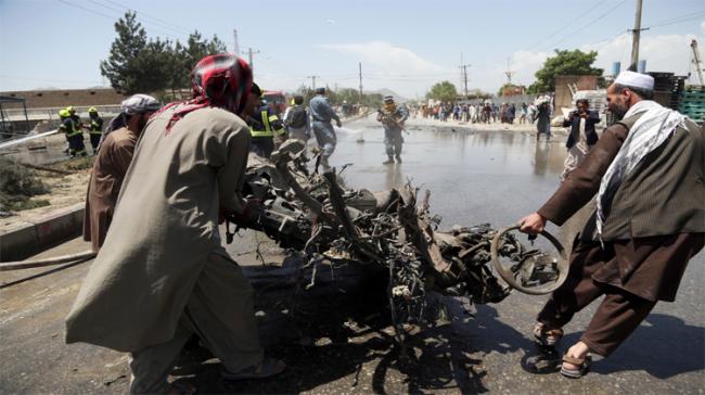 Afghan people carry the remains of suicide attackers vehicle in Kabul, Afghanistan &amp;amp;nbsp; - Sakshi Post