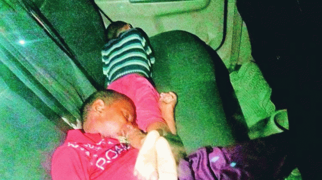 The kids shown lying lifeless in the car. - Sakshi Post