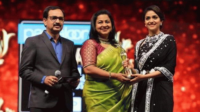 Keerthy Suresh accepting her award - Sakshi Post