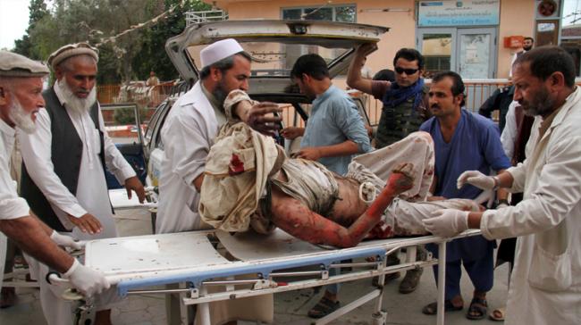 A wounded man is brought by stretcher into a hospital after a mortar was fired by insurgents in Haskamena district of Jalalabad east of Kabul, Afghanistan - Sakshi Post