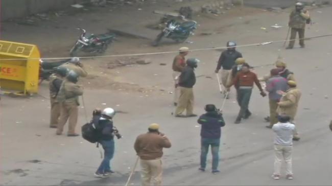 Police use tear gas shells to disperse the protesters in Seelampur (Pic courtesy: ANI) - Sakshi Post