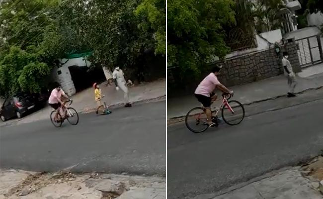 Nara Lokesh  freewheeling on a bike with his son Devansh on in tow on a skateboard and roaming the streets - Sakshi Post