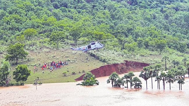 ndian Navy Helicopters Conduct Rescue & Relief Operations in Marooned Villages in Eluru - Sakshi Post